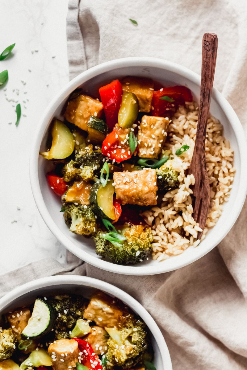 a bowl of vegan stir fry served with brown rice