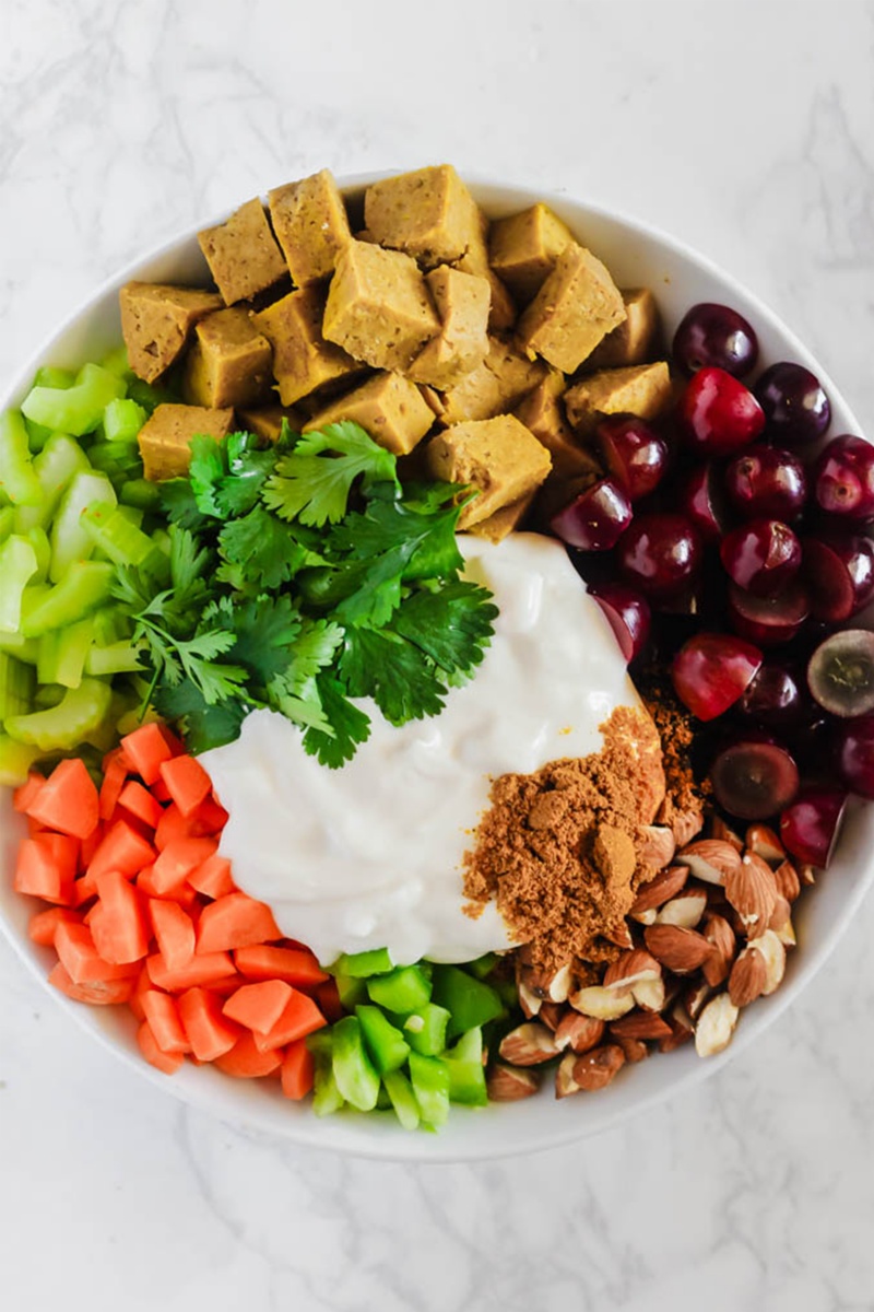 bowl of seitan salad with greens and grapes