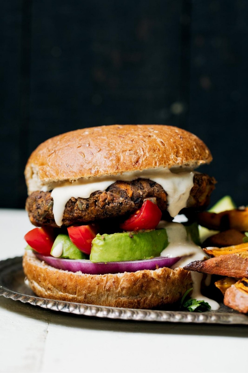 vegan black bean burger on bun with avocado