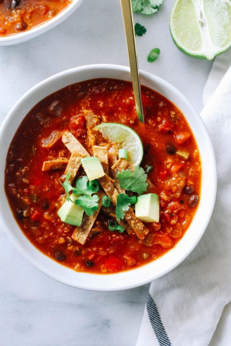 bowl of red vegan chili. and gold spoon