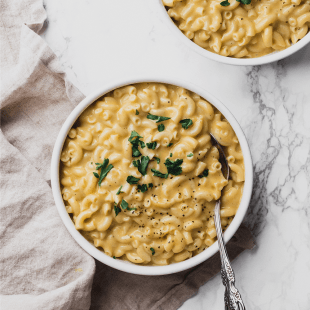 bowl of homemade macaroni and cheese with parsley on top