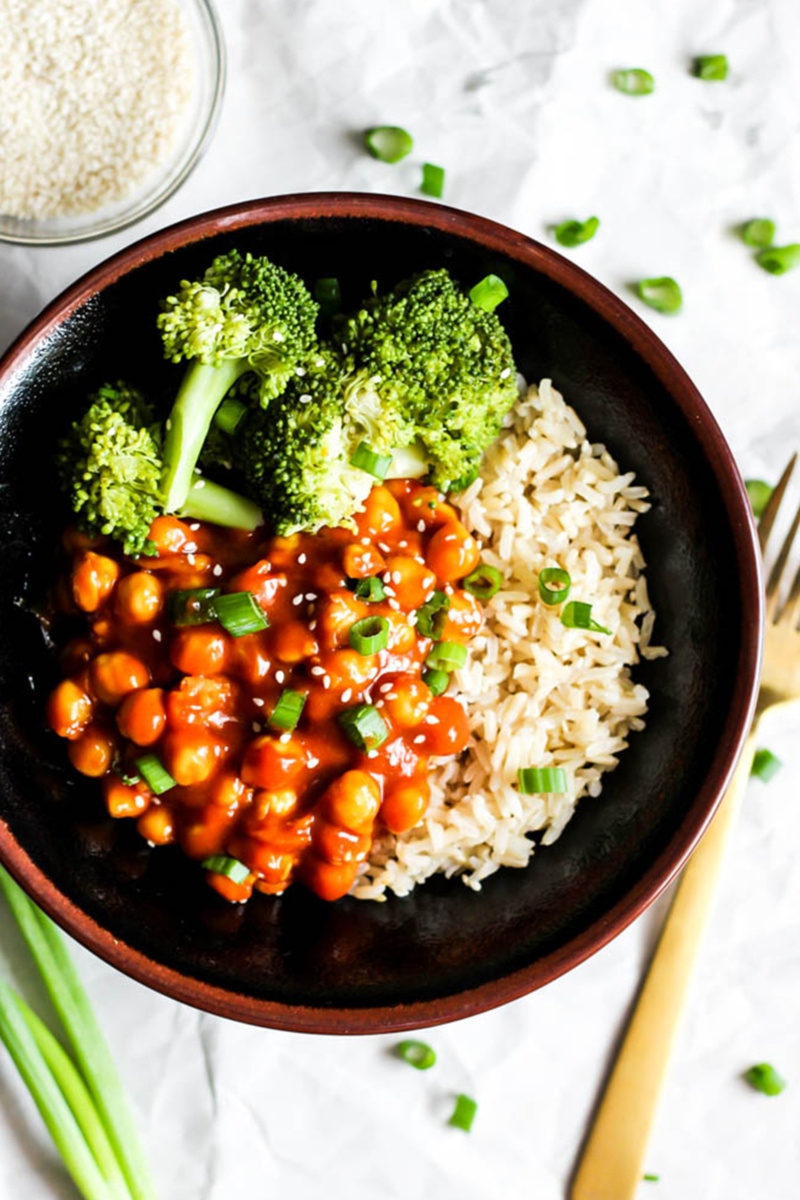 A bowl of sweet and sour chickpeas served with rice and broccoli