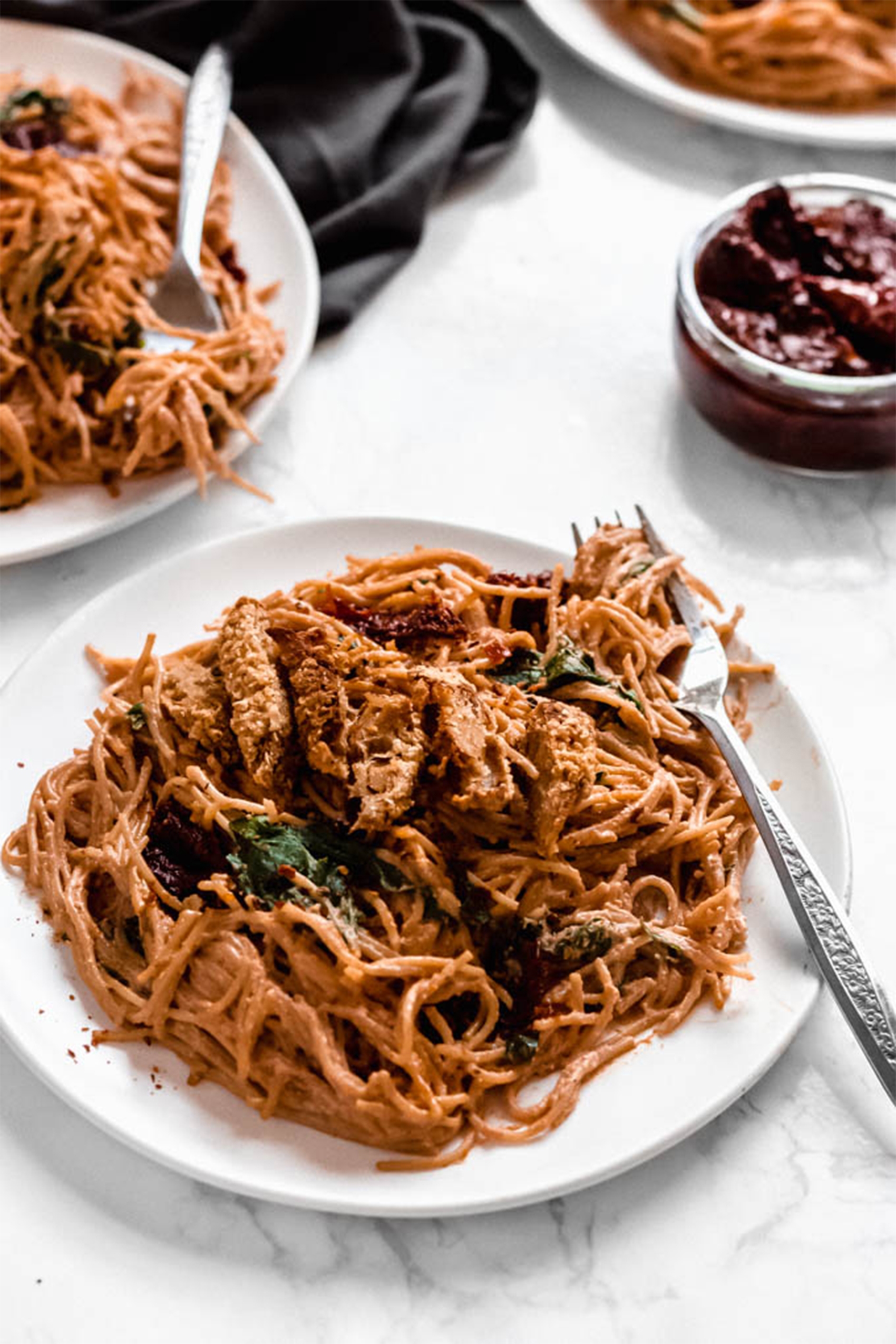 a closeup of a plate of a creamy sun dried tomato pasta