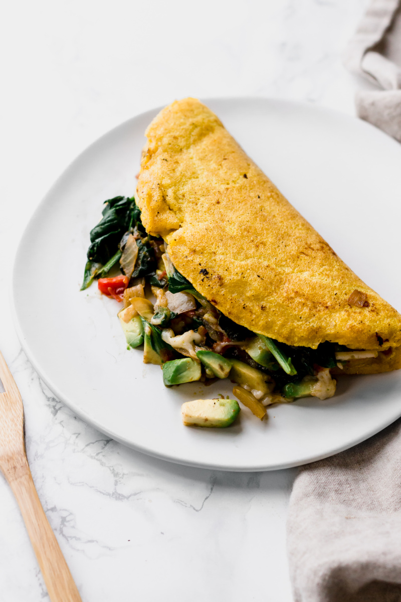 close up of omelette with spinach and avocado