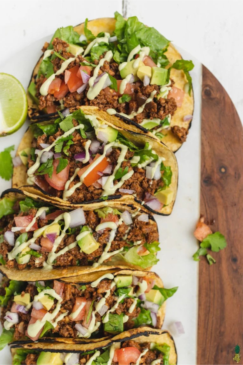 a platter of walnut mushroom tacos topped with cashew crema