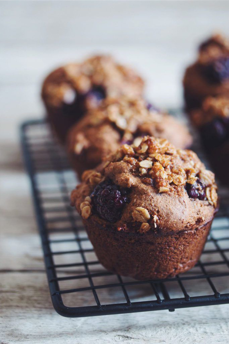 Blackberry crumble muffins resting on a cooling rack