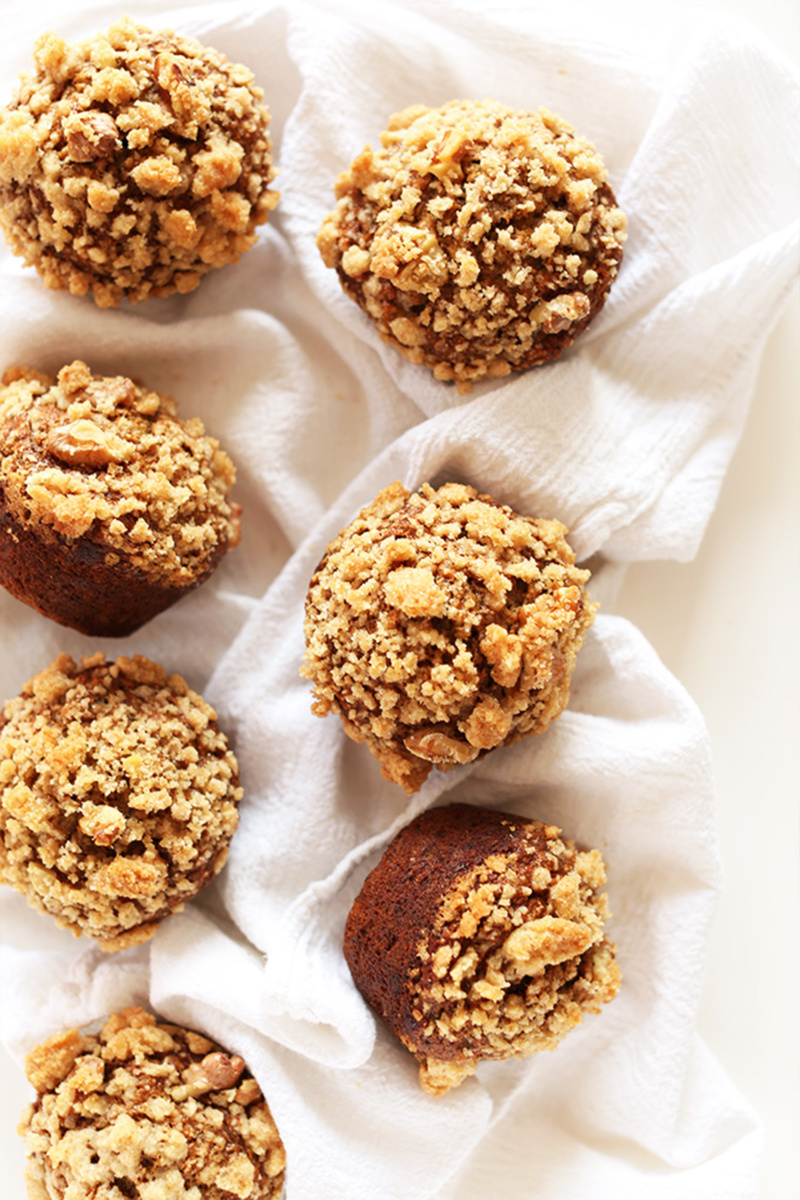 vegan banana crumble muffins resting on a white dish towel