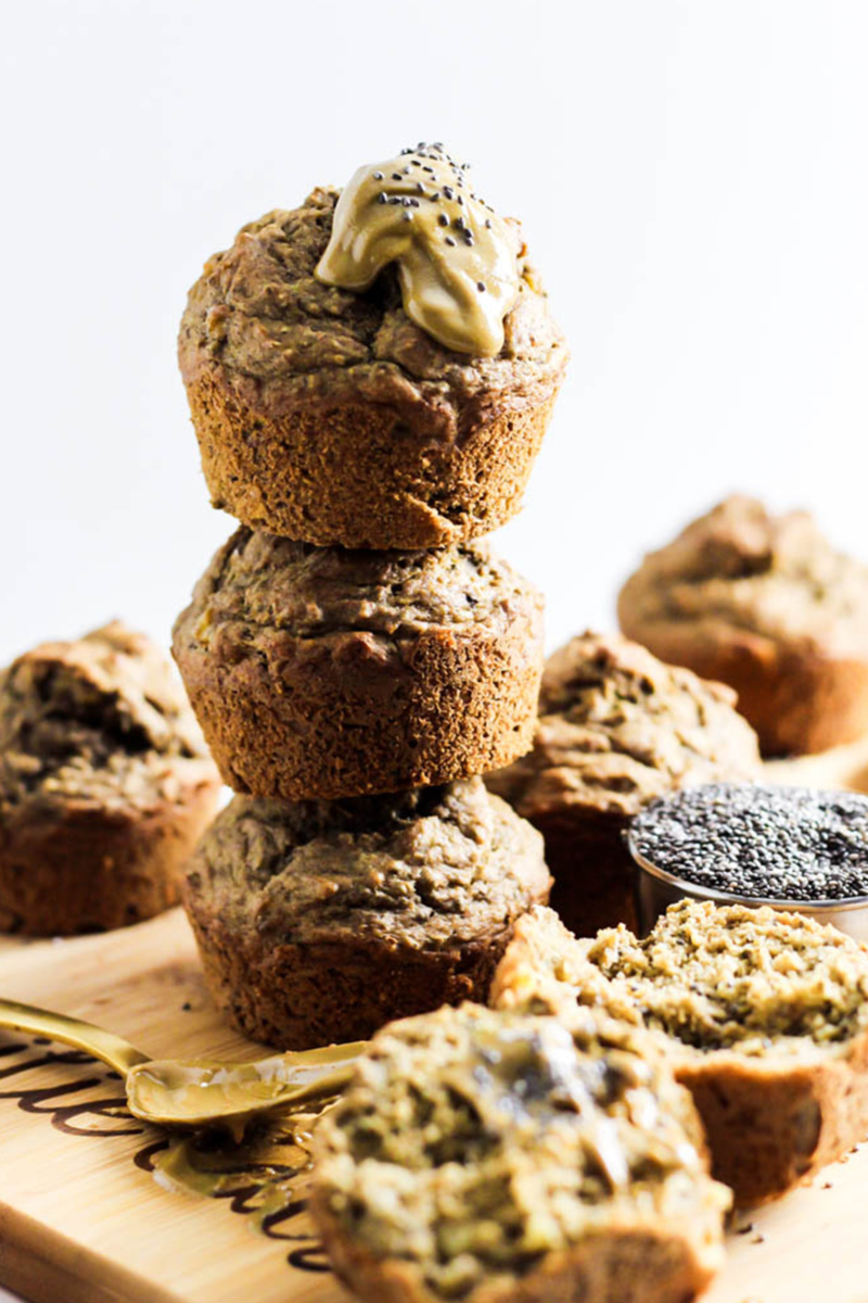 almond butter chia muffins served on a wooden cutting board and topped with almond butter