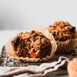 A close up shot of two vegan carrot cake muffins