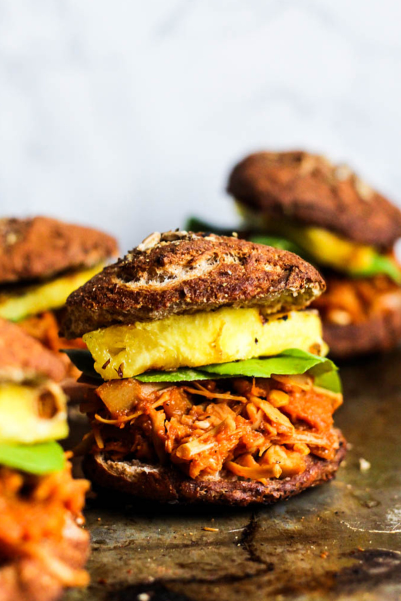 vegan bbq jackfruit sandwiches topped with pineapple and lettuce