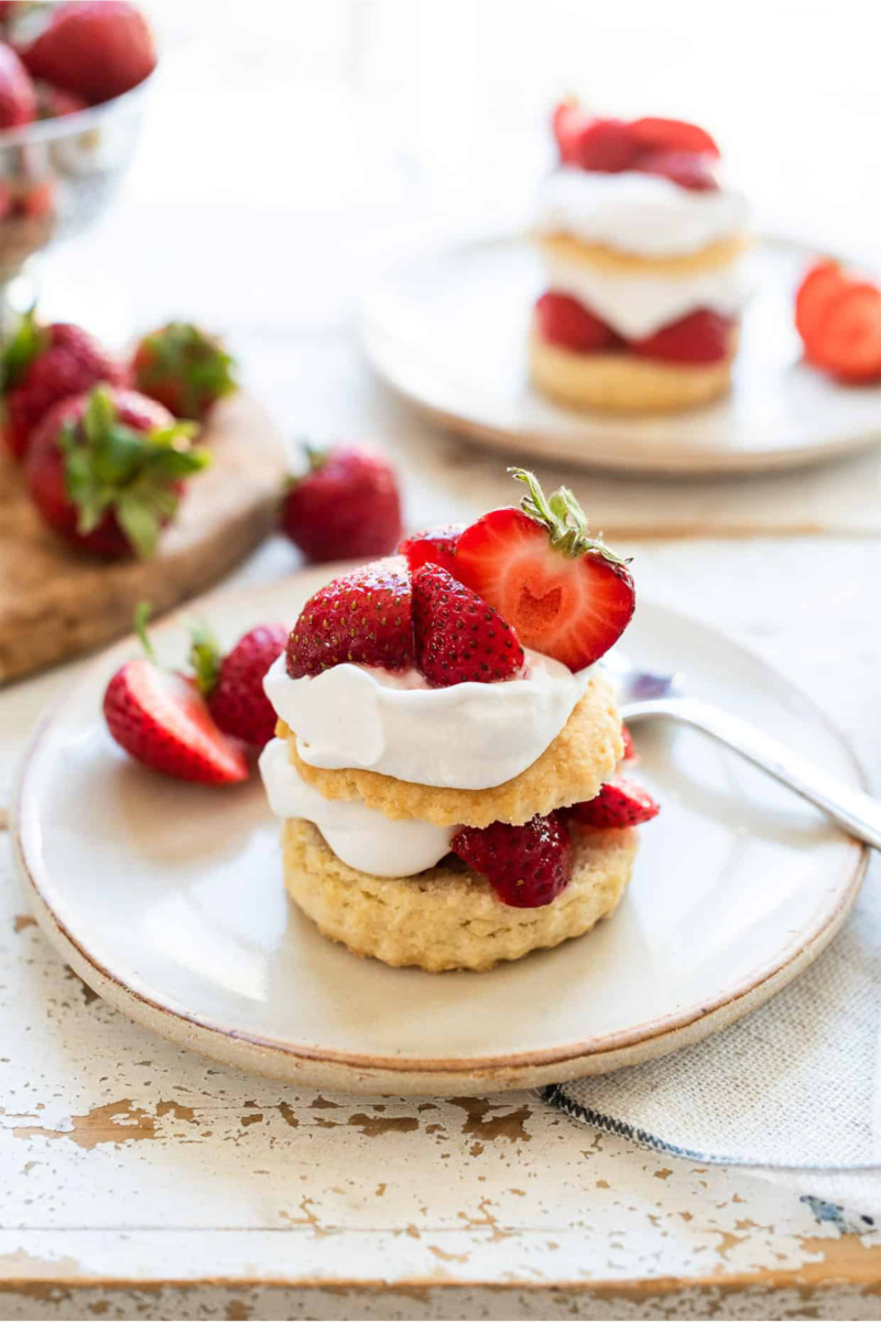 a strawberry shortcake topped with vegan whipped cream and fresh strawberries