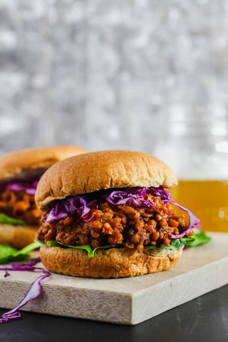 bbq lentil sloppy joe sandwiches topped with lettuce and purple cabbage