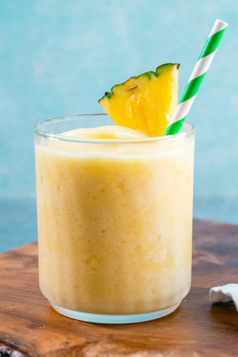 a pineapple smoothie with a wedge of pineapple