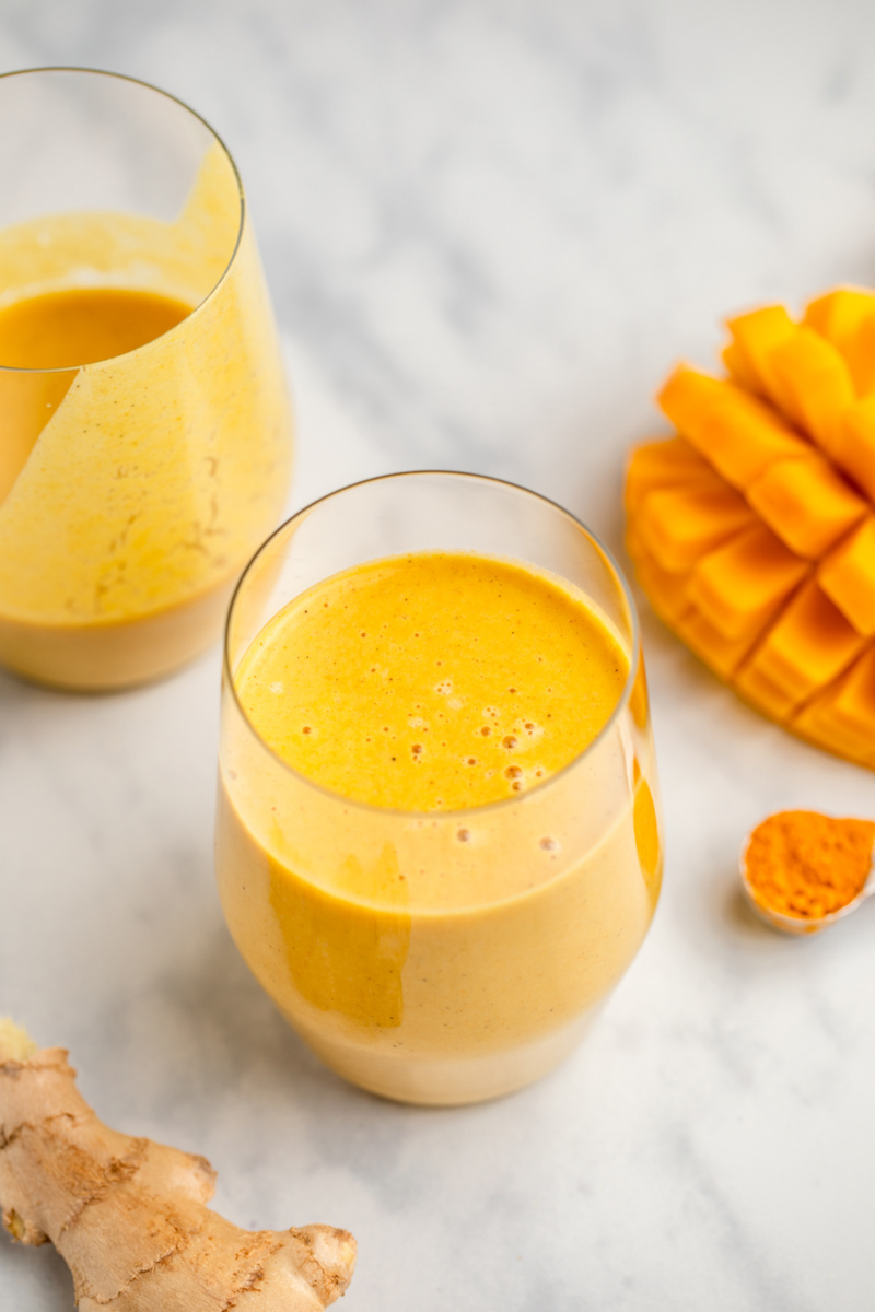 two cups of mango turmeric smoothie