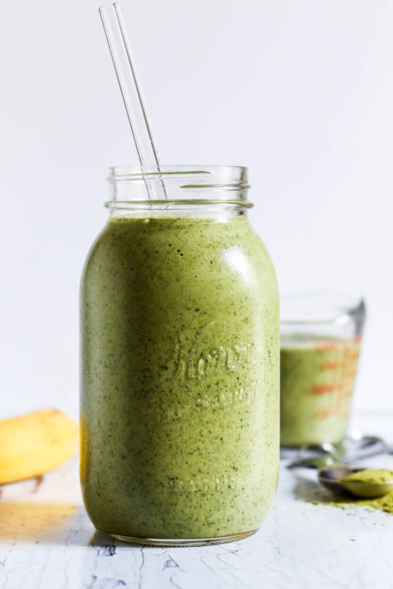 a matcha smoothie with a glass straw