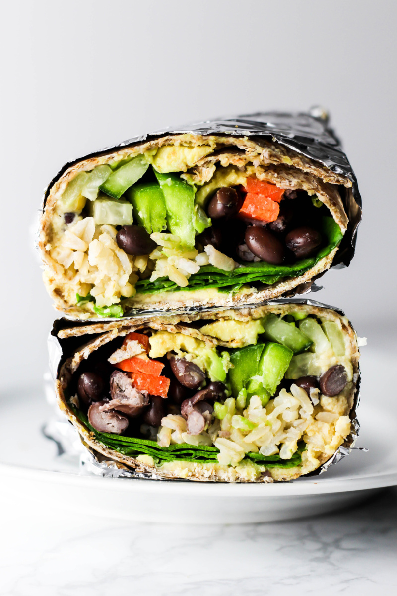 a veggie hummus wrap cut in half and wrapped in foil