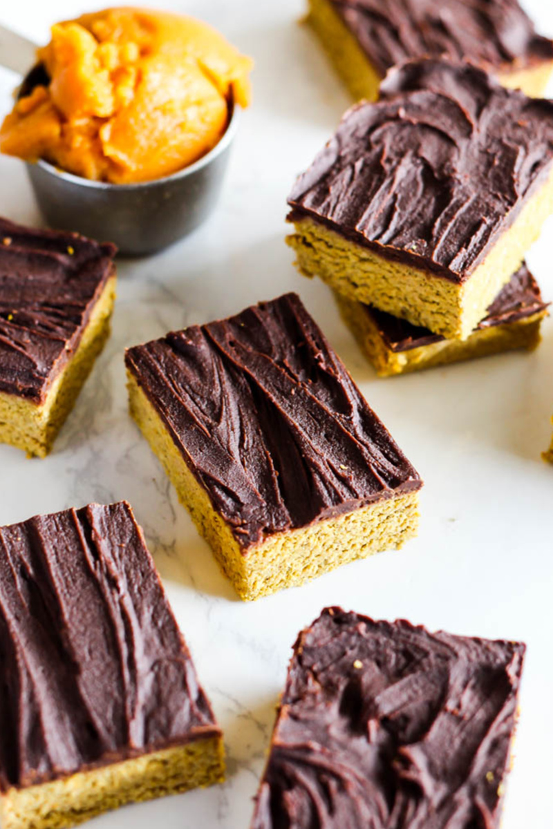 seven homemade pumpkin protein bars topped with a layer of chocolate