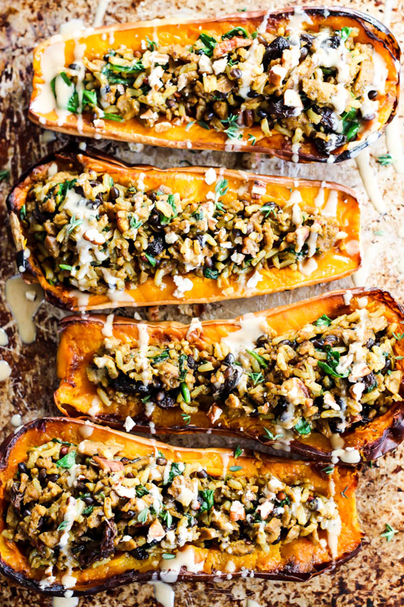 butternut squashes that have been filled with a grain and vegan sausage filling