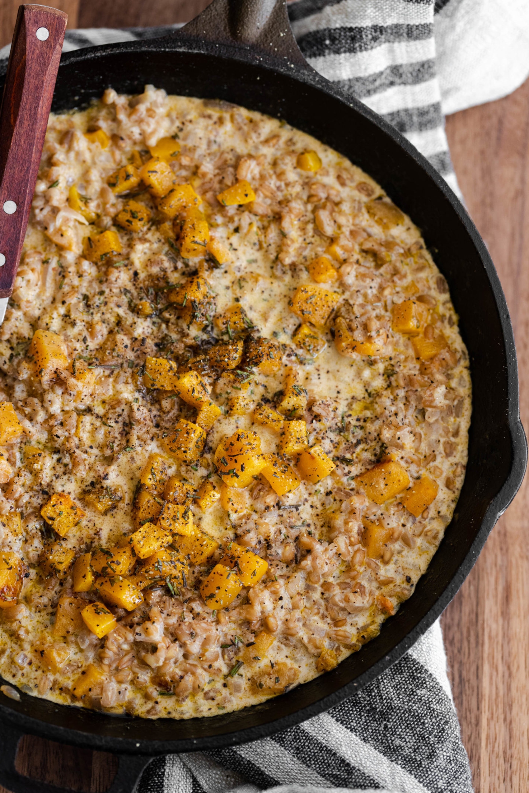 a pan filled with a farro risotto including butternut squash
