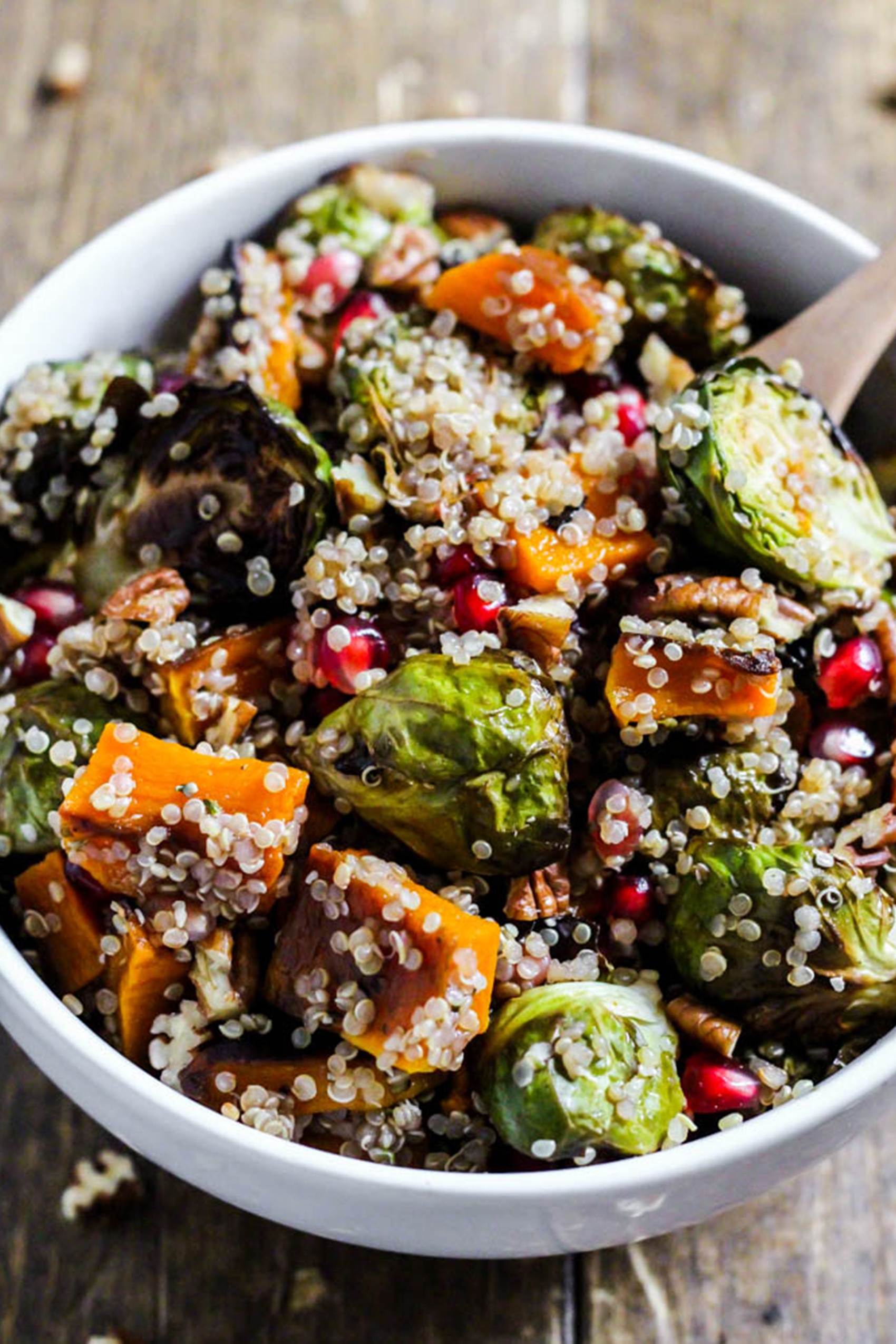 a quinoa salad including brussels sprouts, pomegranate seeds, and squash