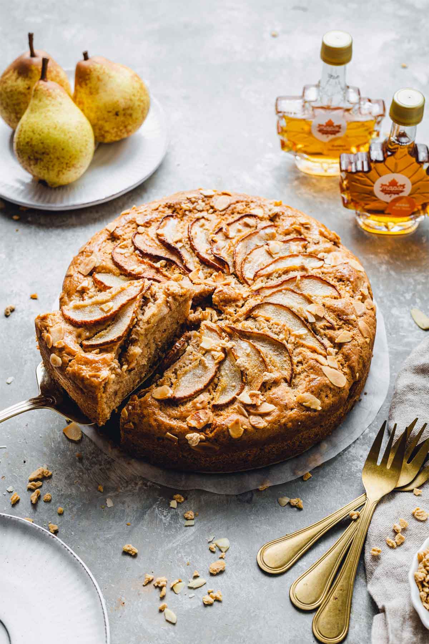 a slice being removed from a pear cake