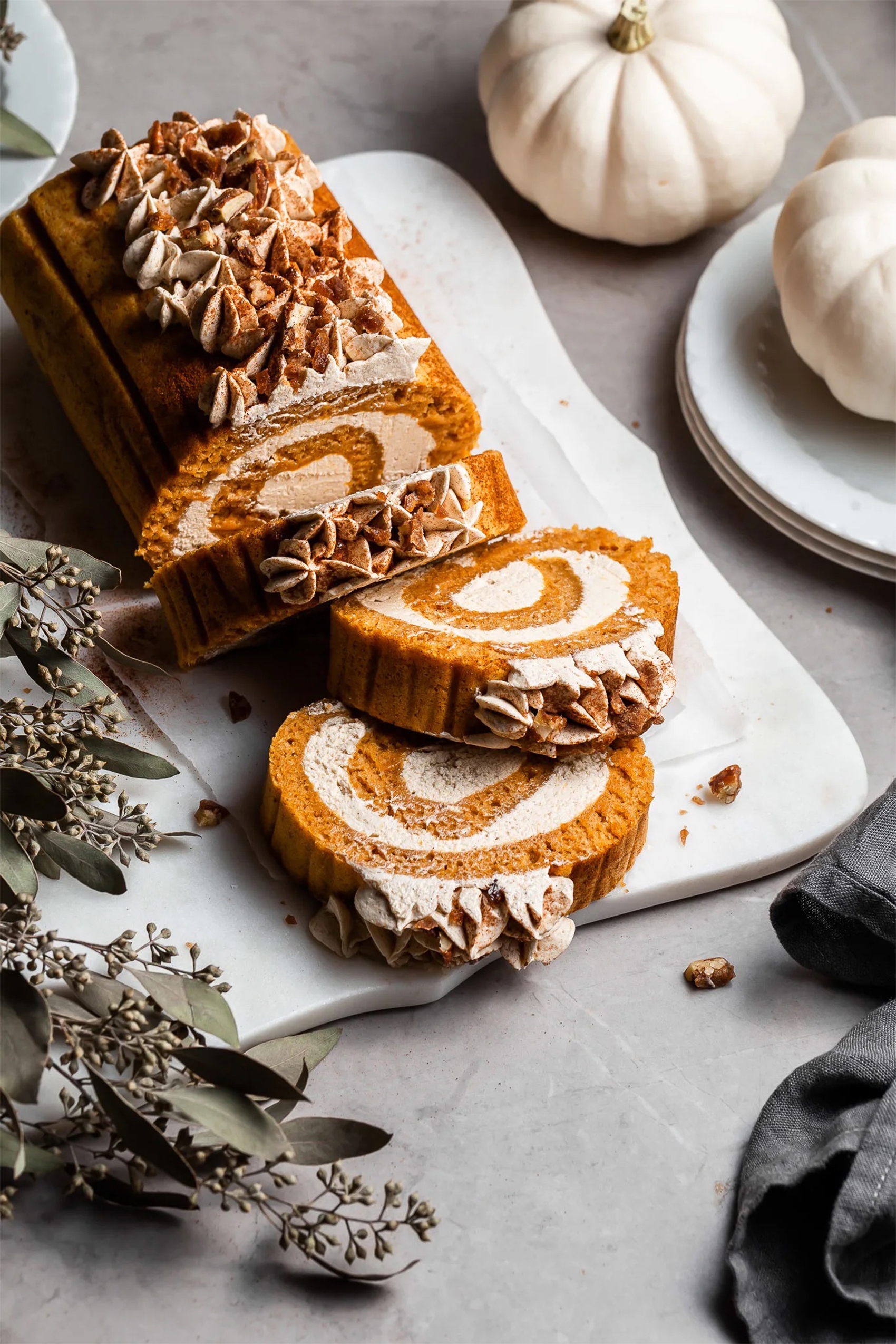 a whole pumpkin swiss roll that has had three slices cut
