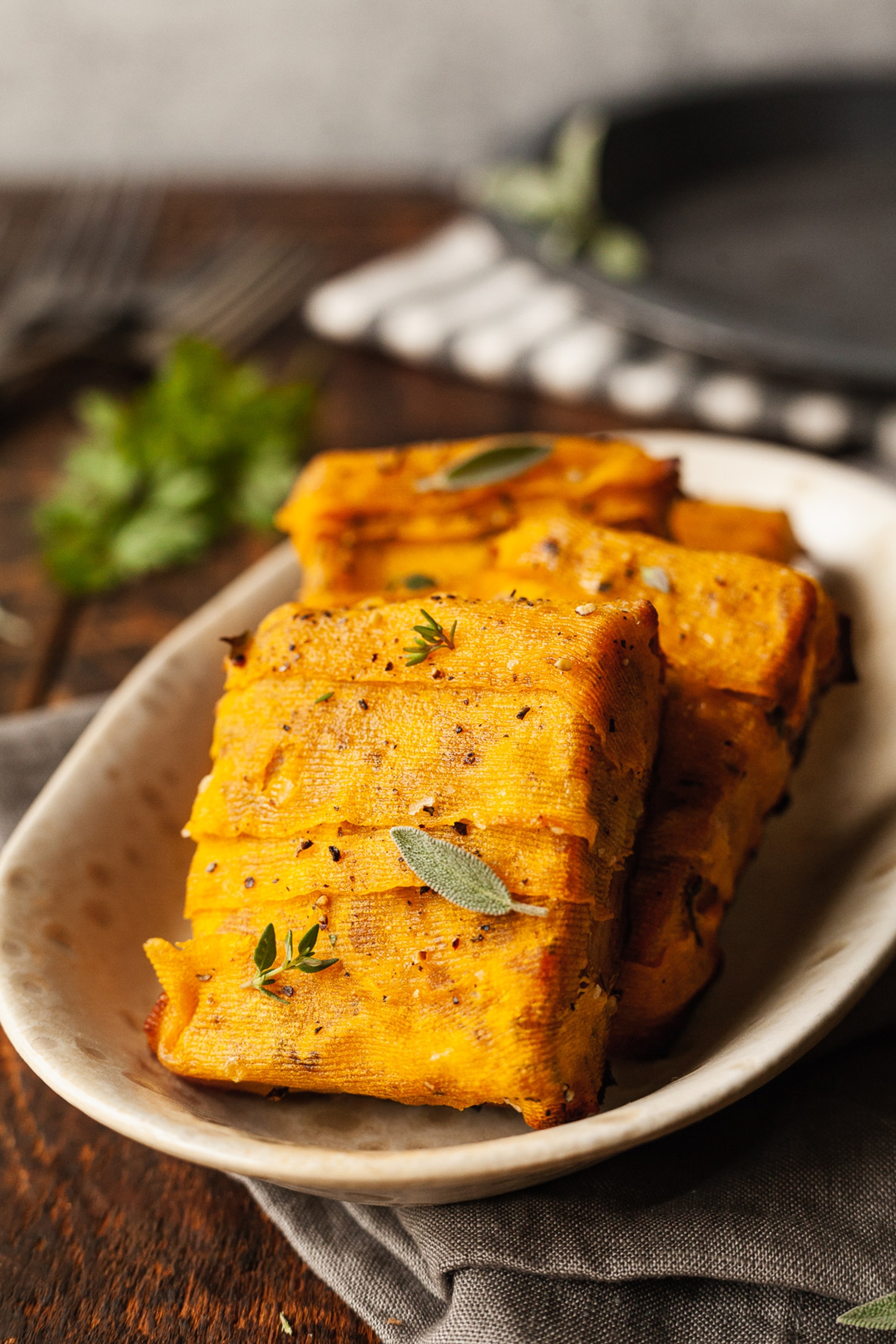 blocks of roasted tempeh topped with sage