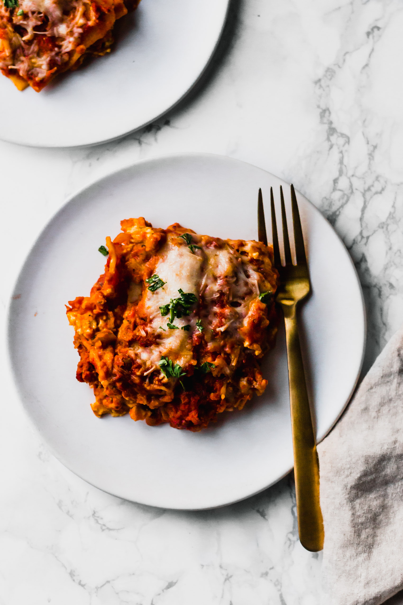 a slice of vegan lasagna on a white plate