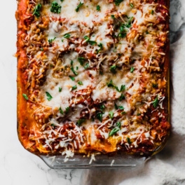 a casserole dish of vegan lasagna topped with fresh parsley