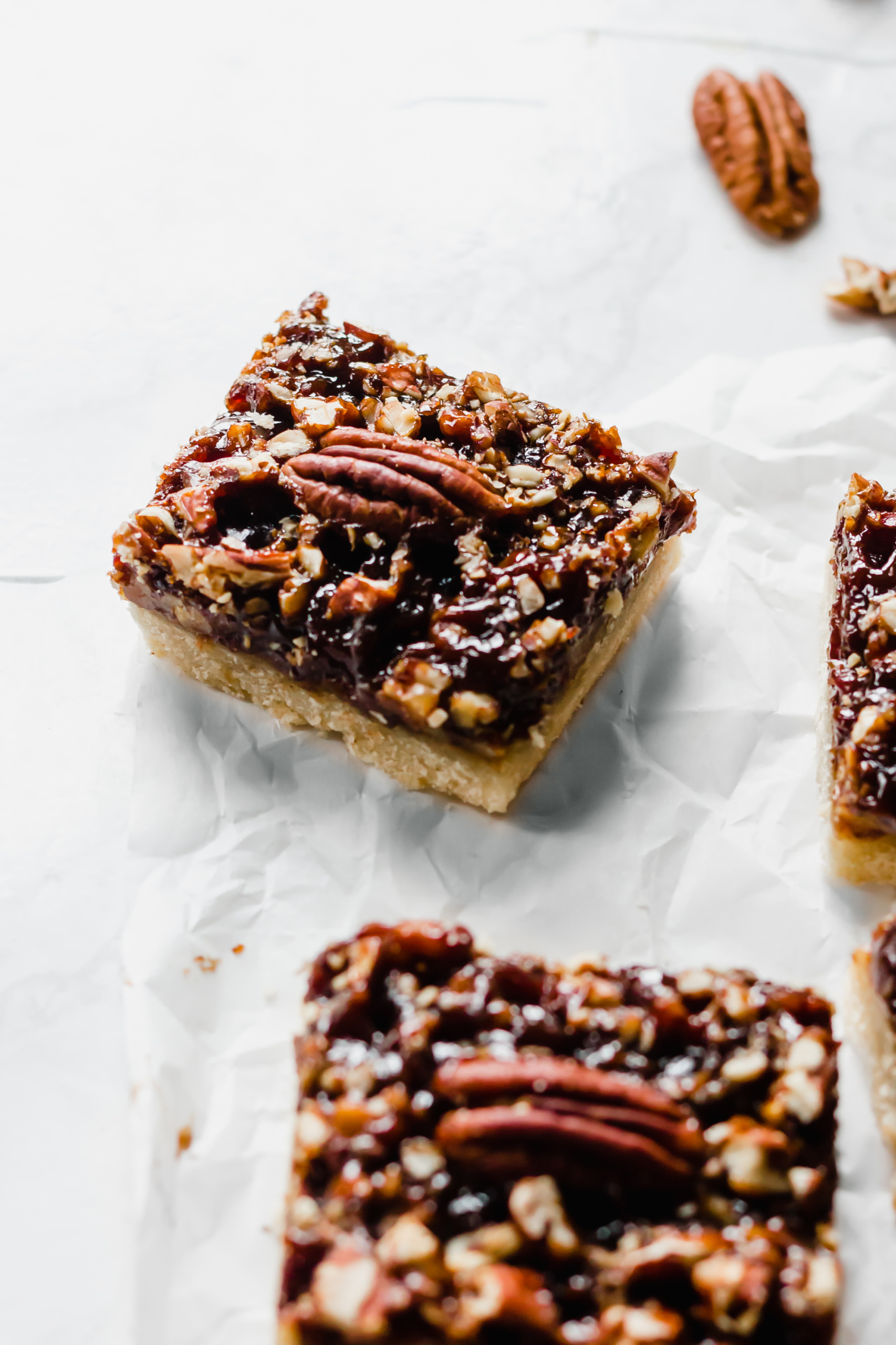 a pecan pie bar topped with a pecan