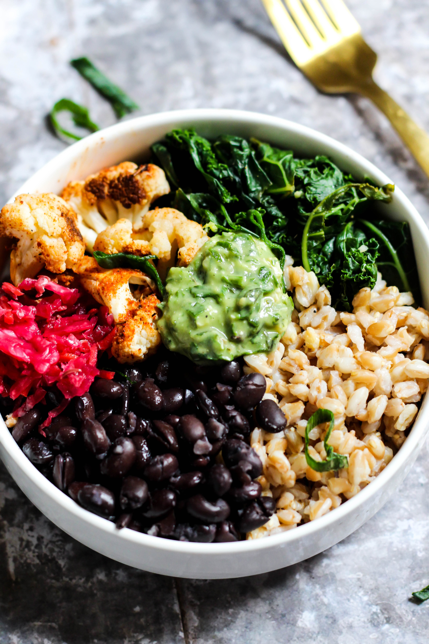 a power bowl filled with grains, greens, vegetables and black beans