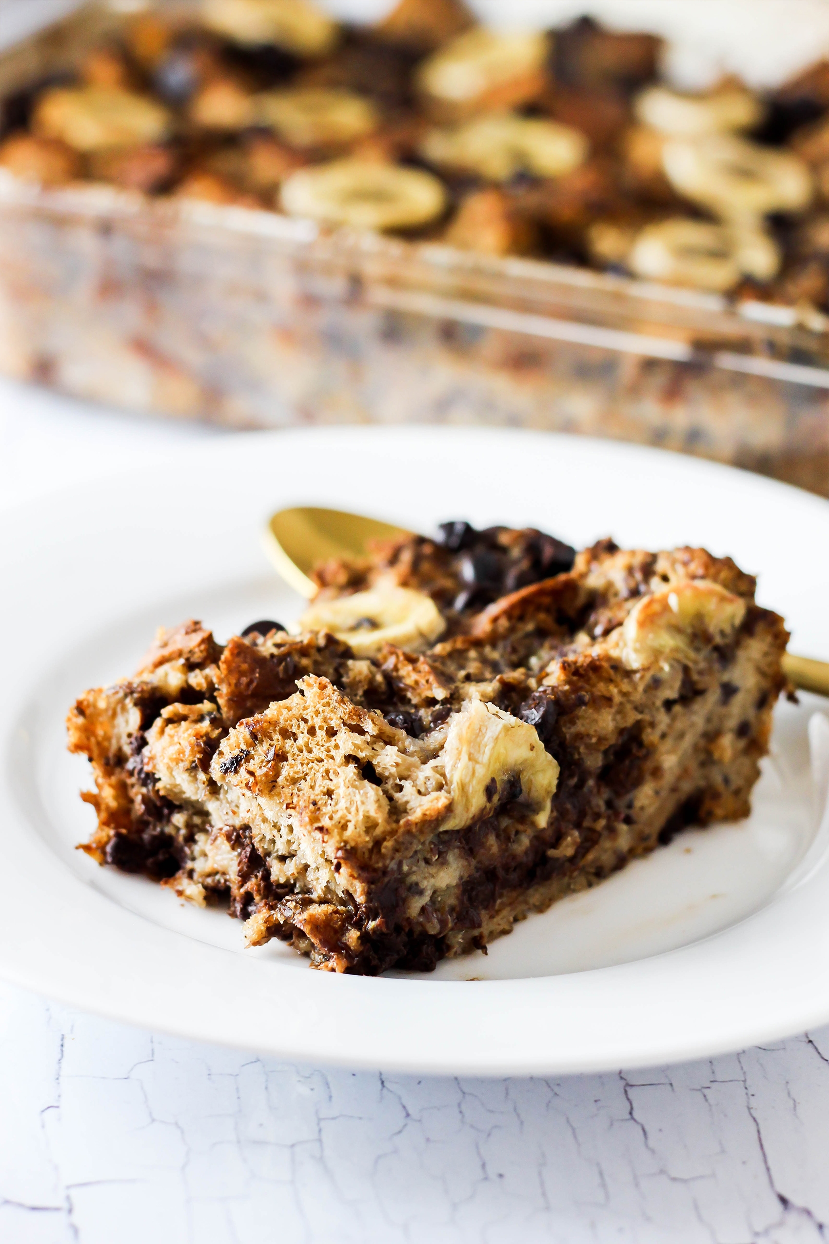 a slice of vegan french toast casserole topped with sliced bananas
