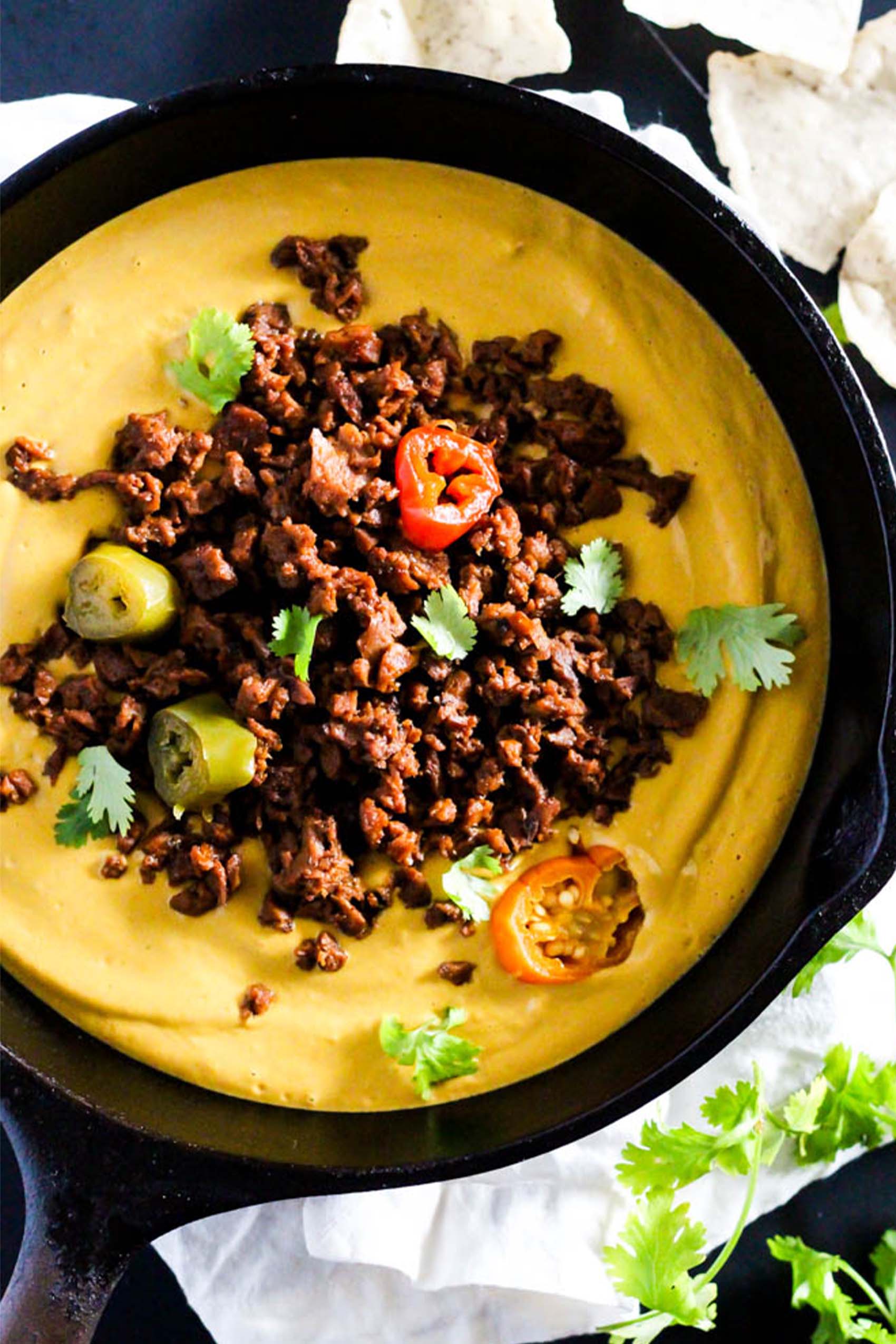 a cast iron skillet of vegan chili cheese dip