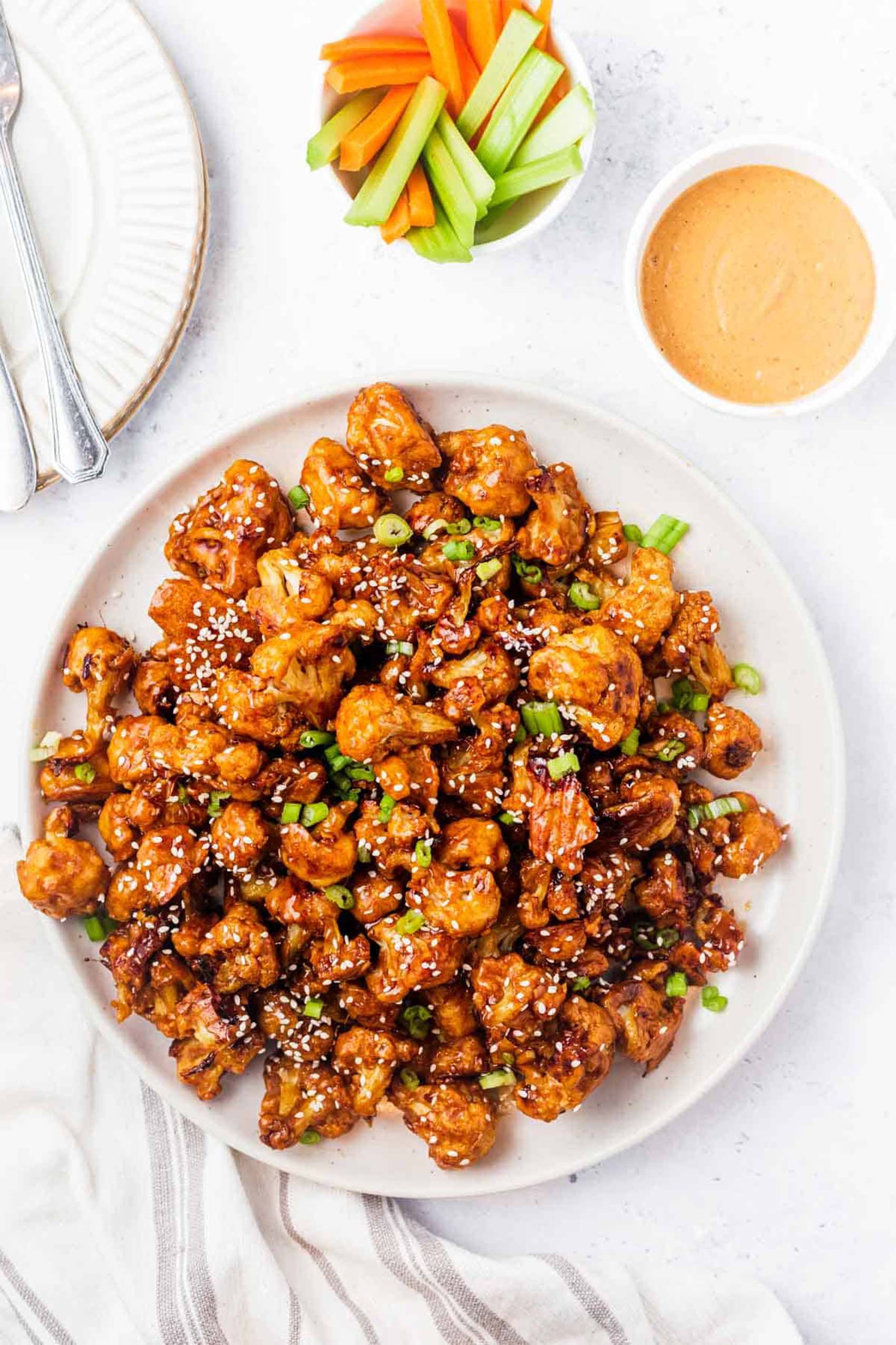 a plate of honey garlic cauliflower wings