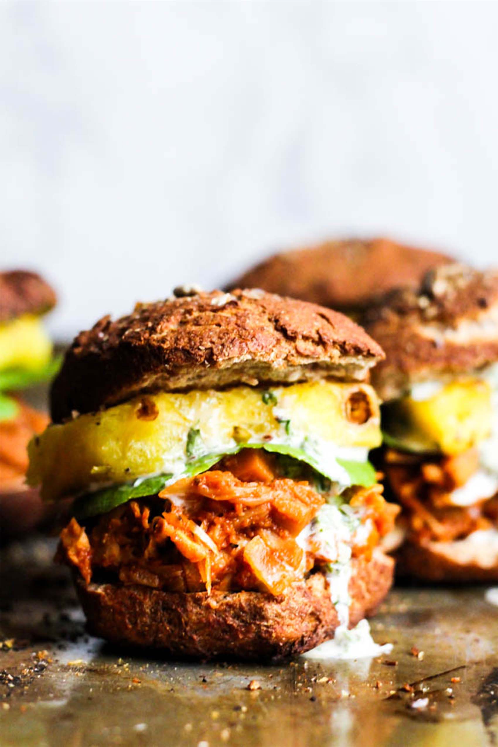 a batch of bbq jackfruit sliders topped with pineapple