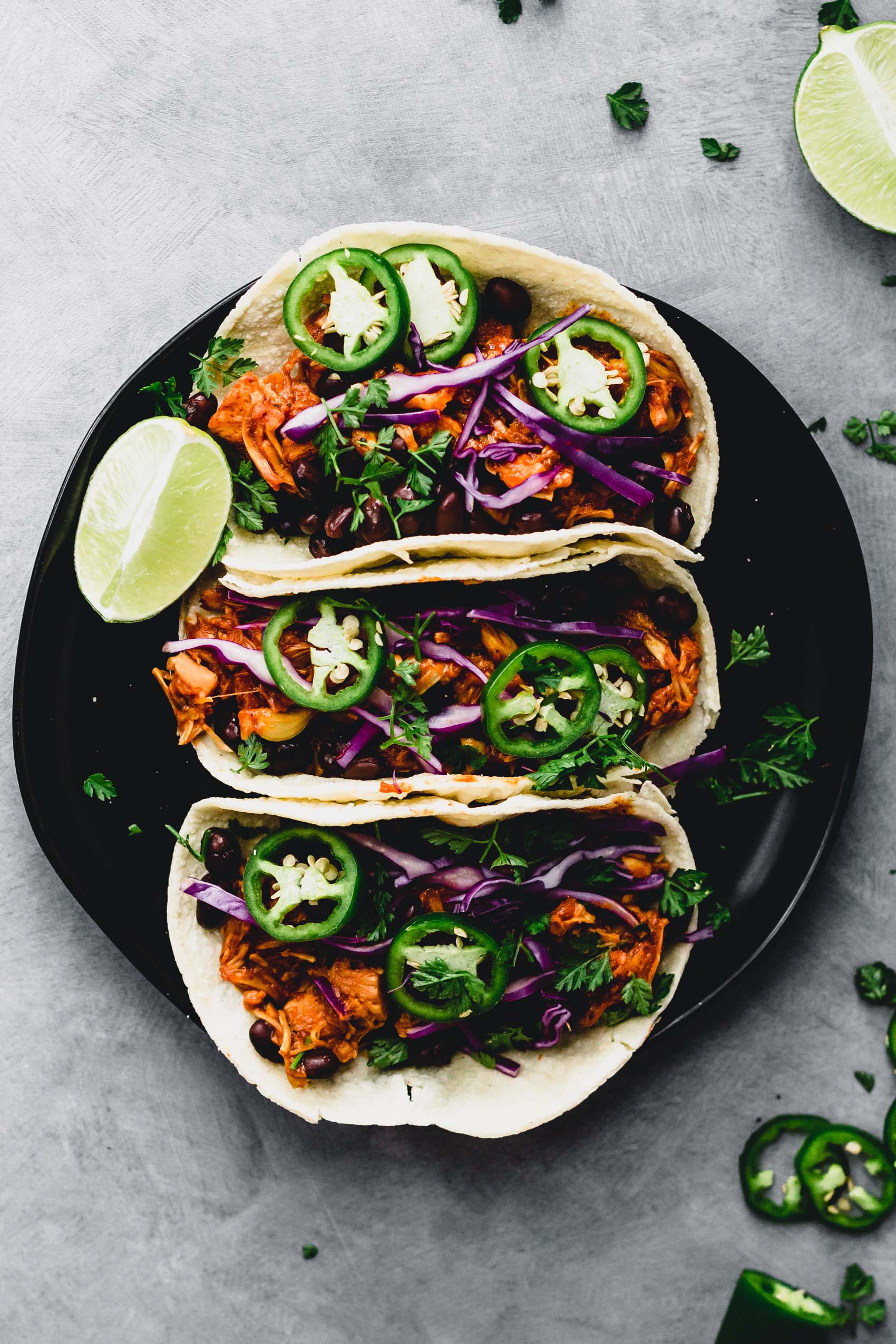 a plate of three vegan bbq jackfruit tacos