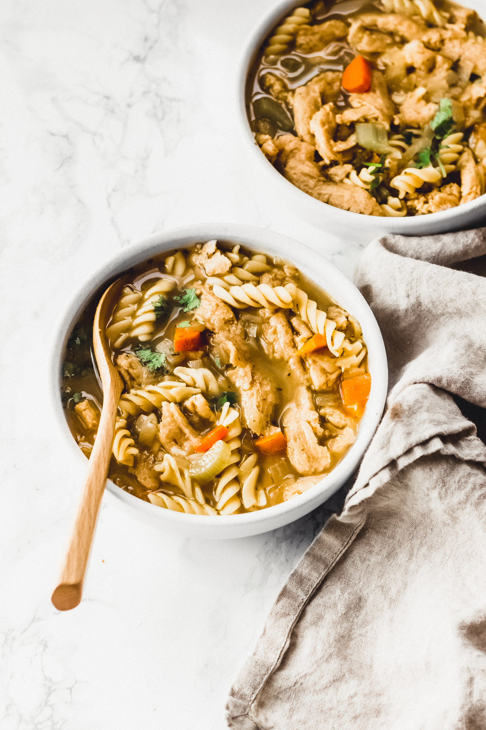 two bowls of vegan chicken noodle soup