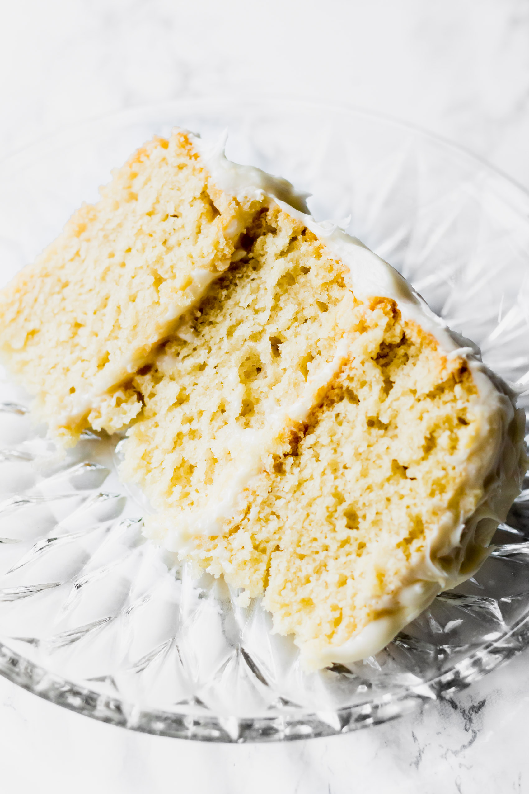 a slice of vanilla cake with three layers