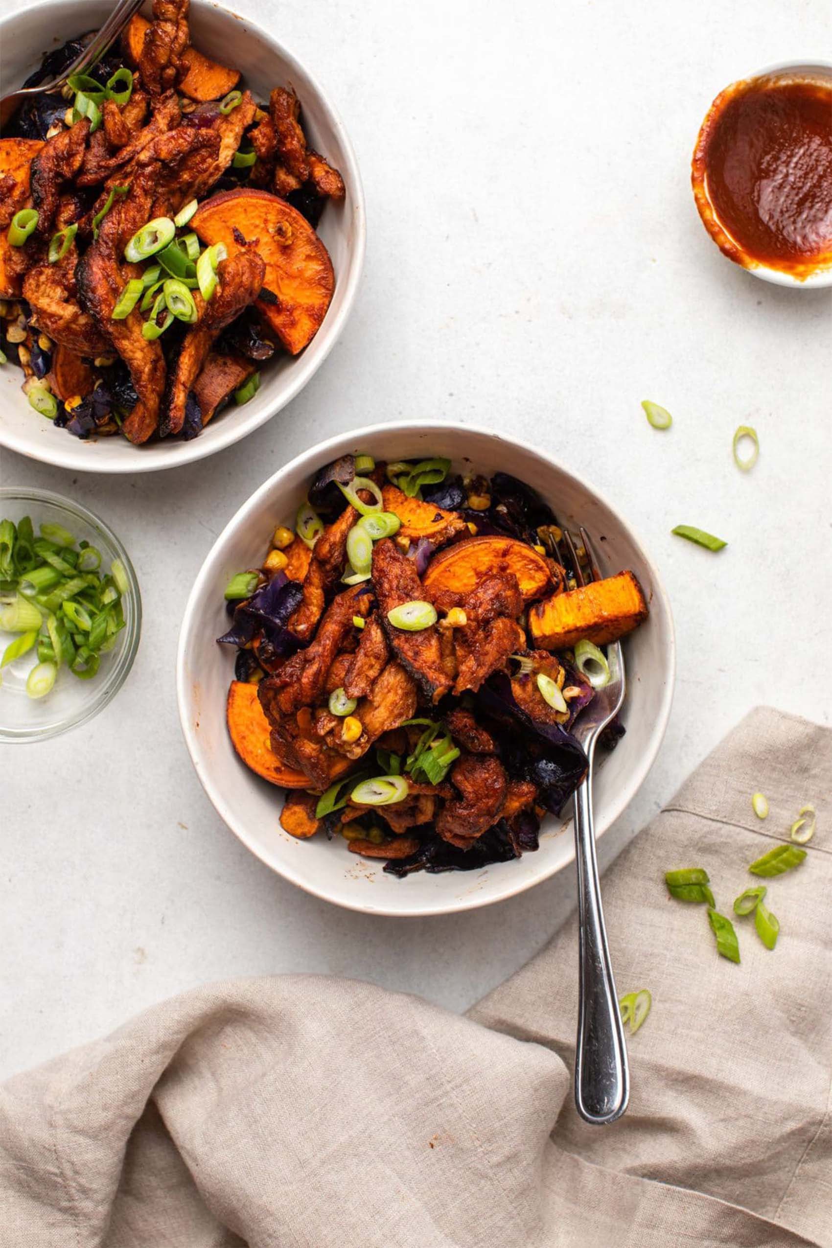 two bowls of vegan barbecue soy curls served with roasted vegetables