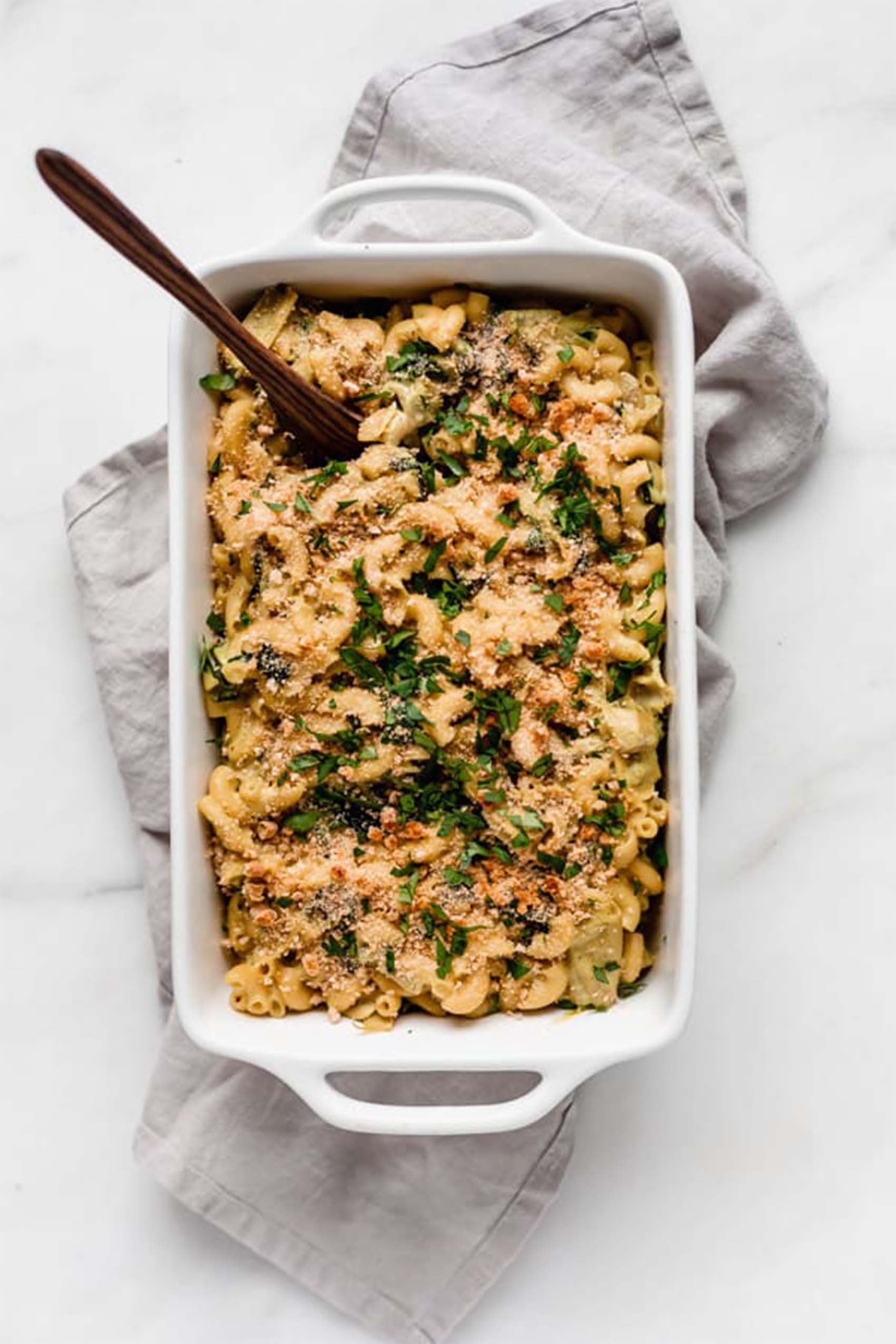 a casserole dish of vegan spinach artichoke mac and cheese