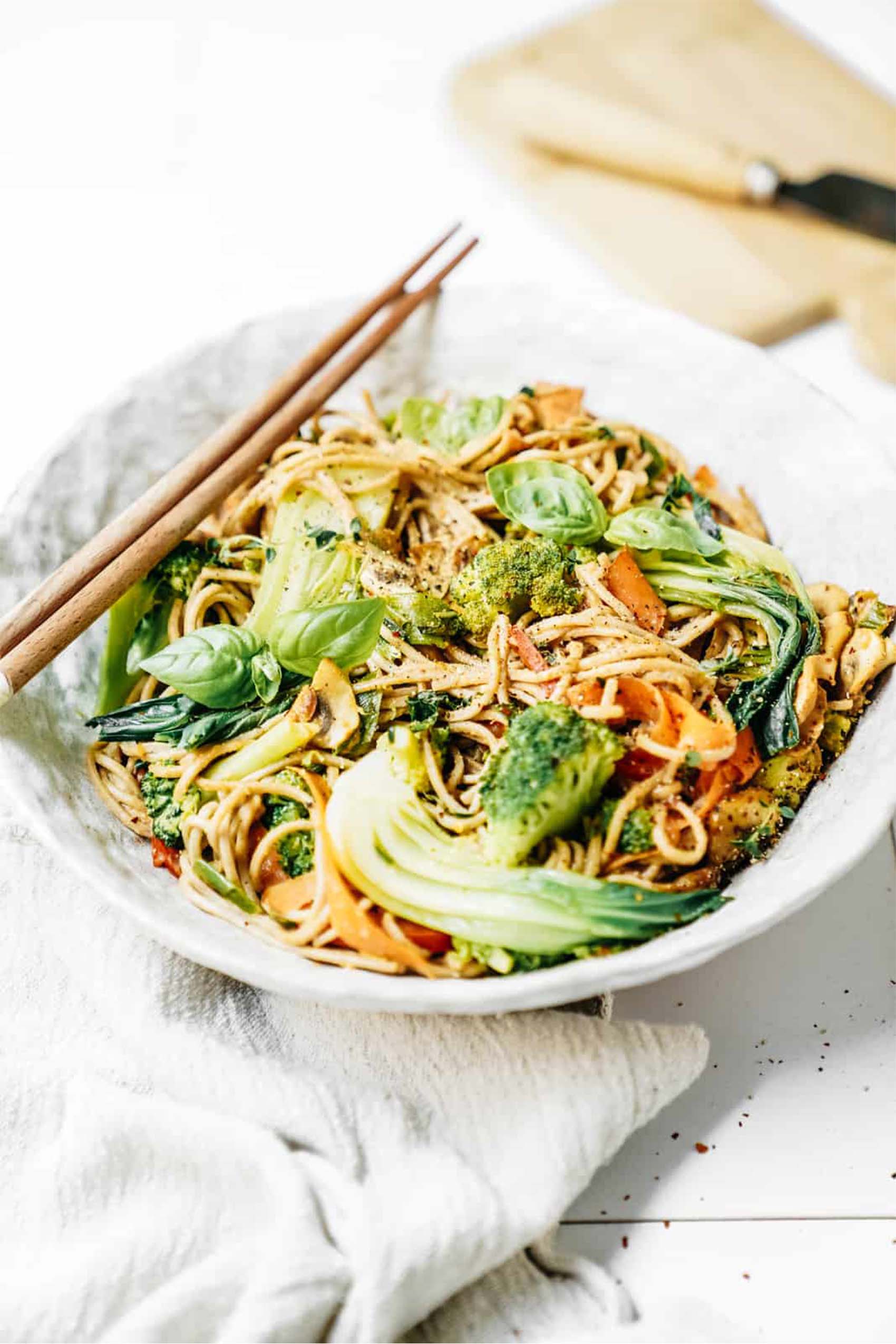 a bowl of vegan stir fry noodles served with bok choy