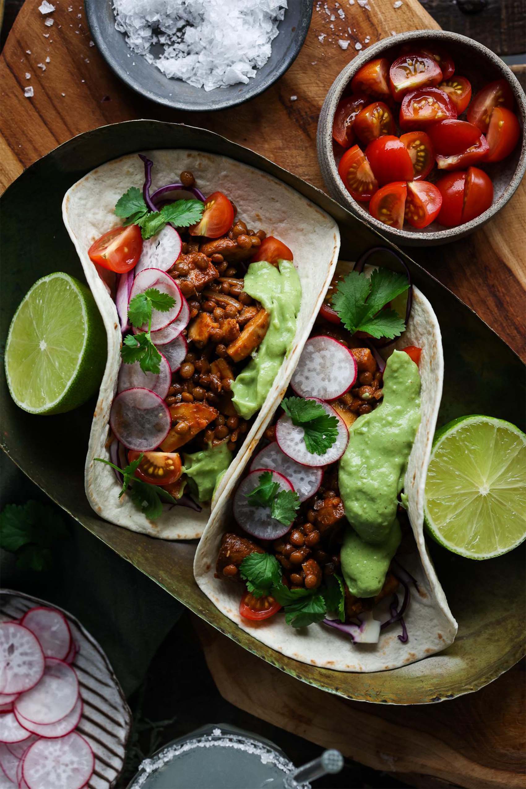 two vegan mushroom lentil tacos served with lime