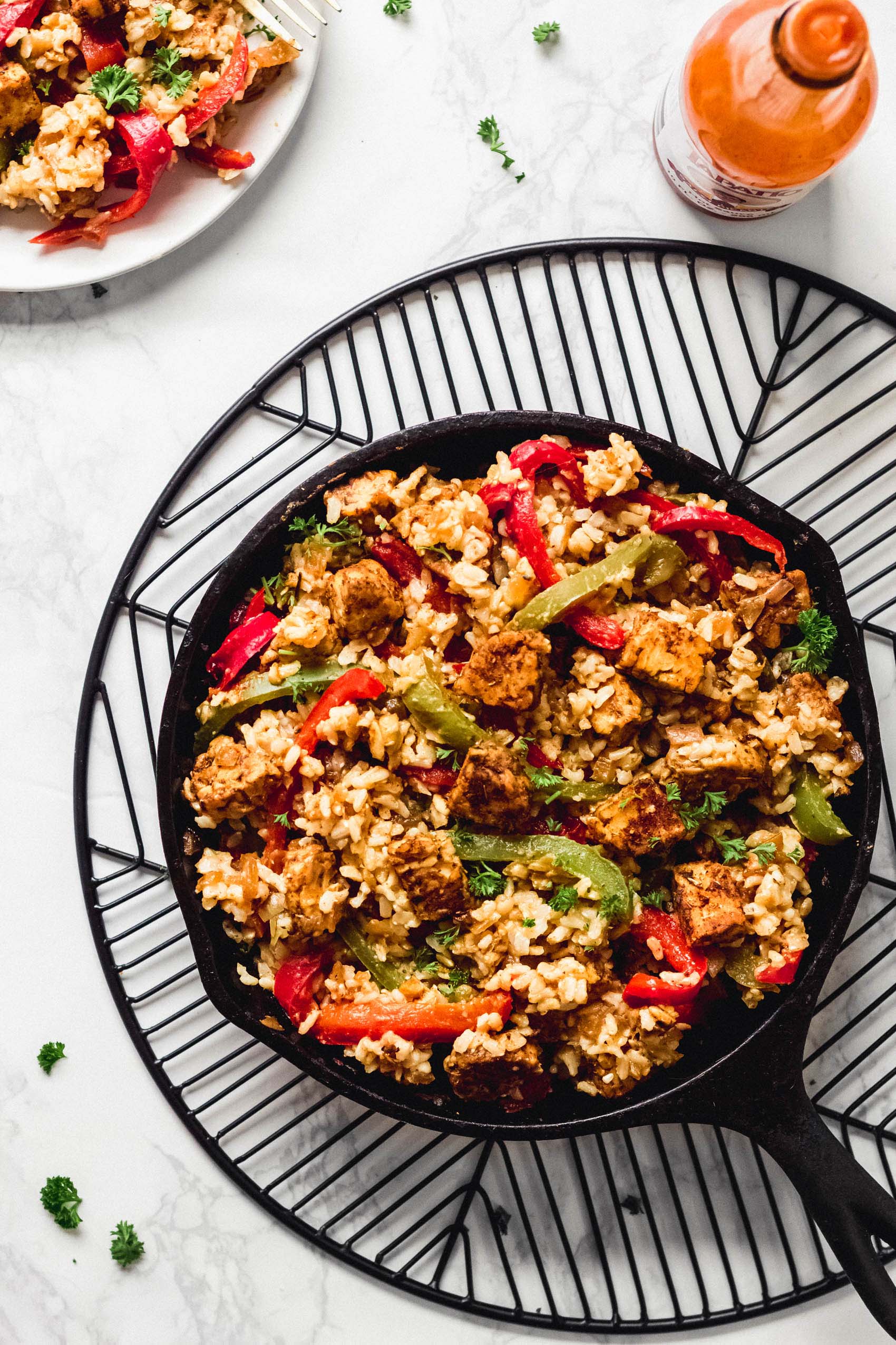 a skillet of rice, peppers and tempeh