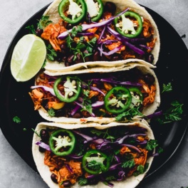 a plate of three jackfruit tacos