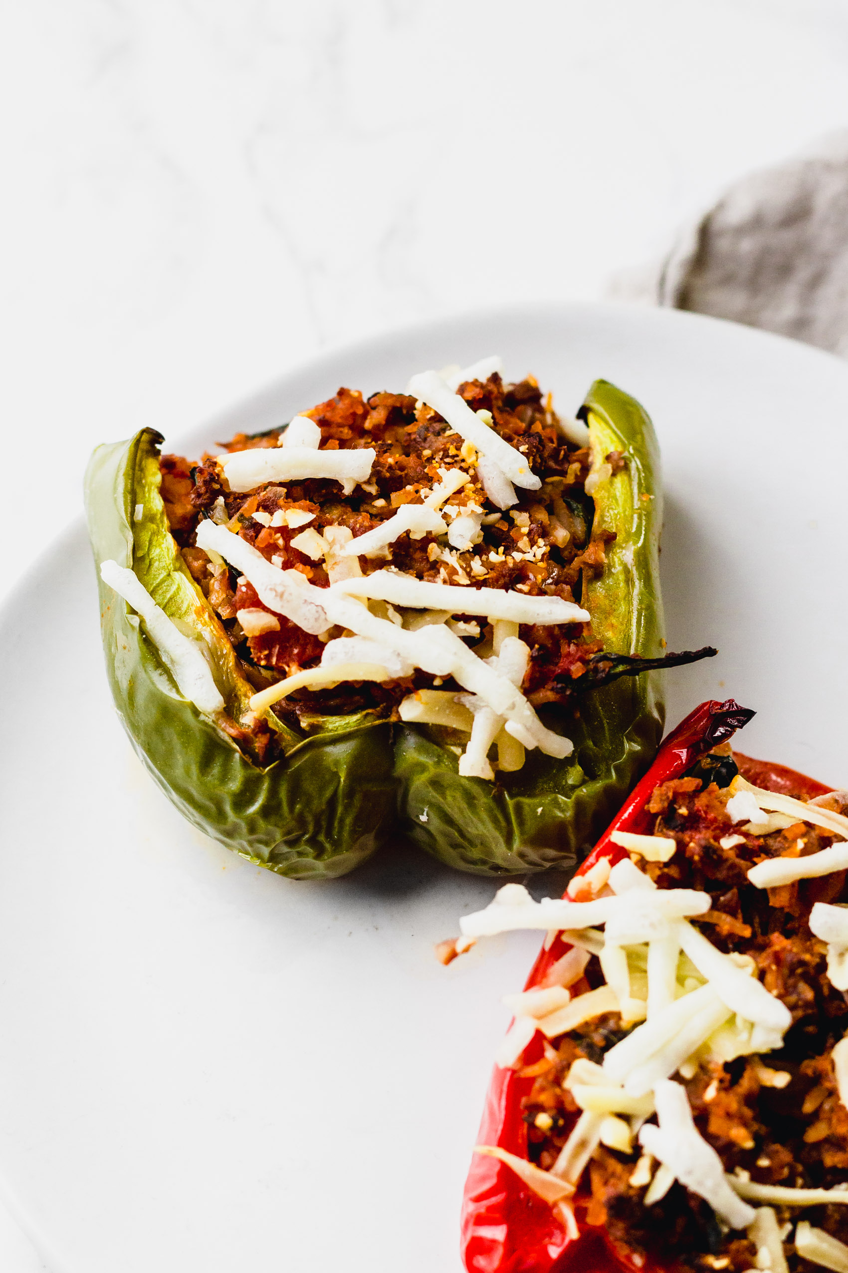 a plate of two stuffed bell peppers