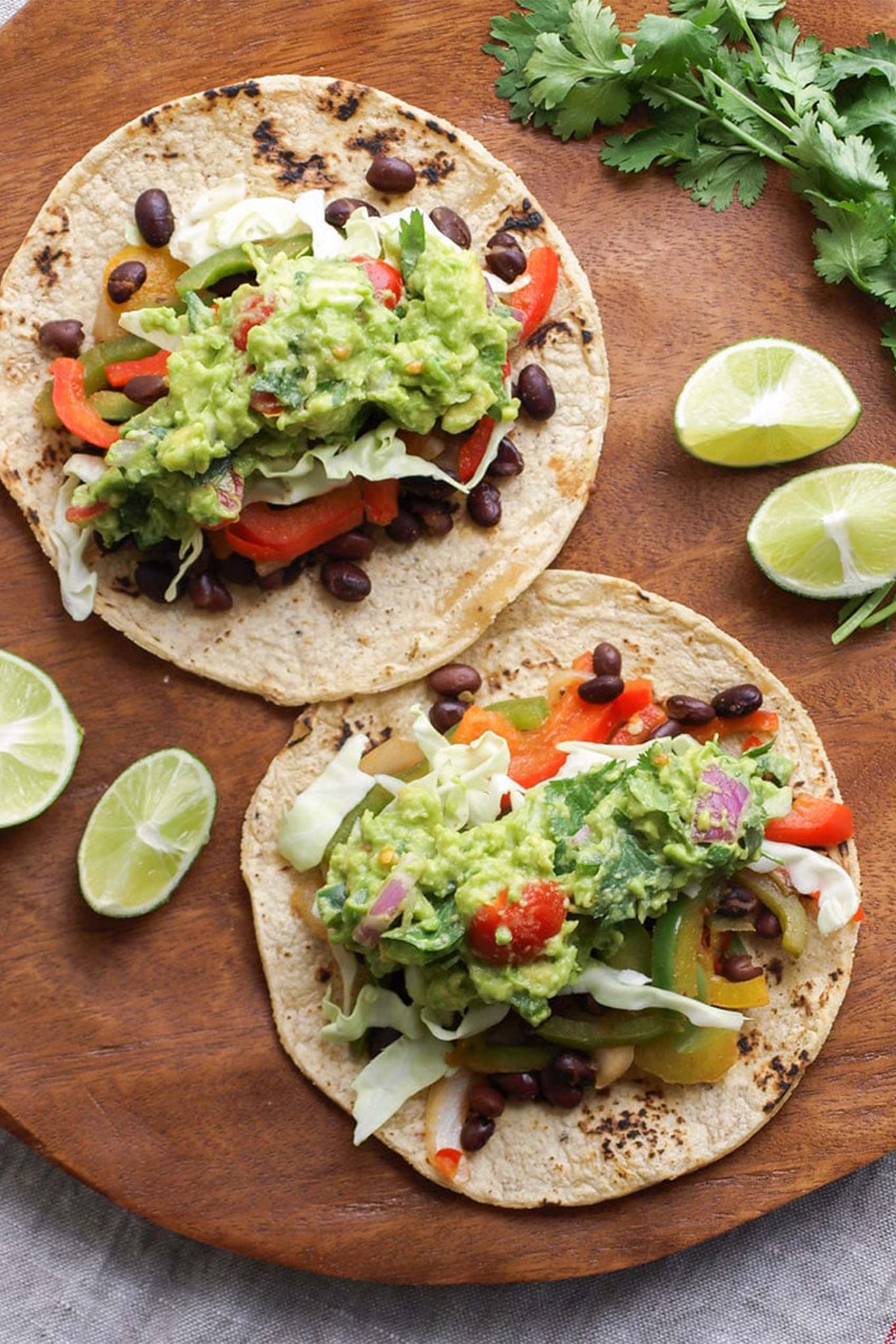 two black bean tacos topped with guacamole