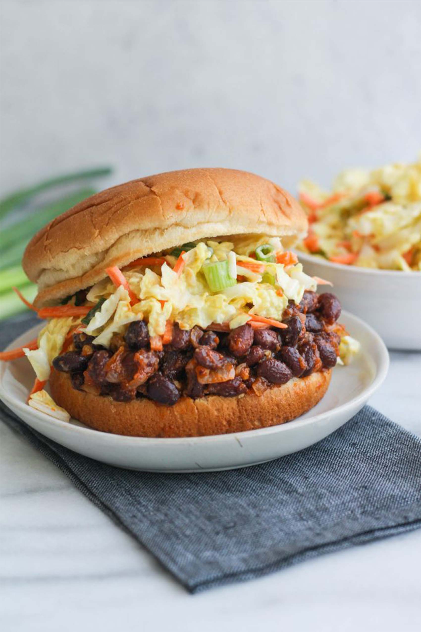 a black bean sandwich topped with slaw