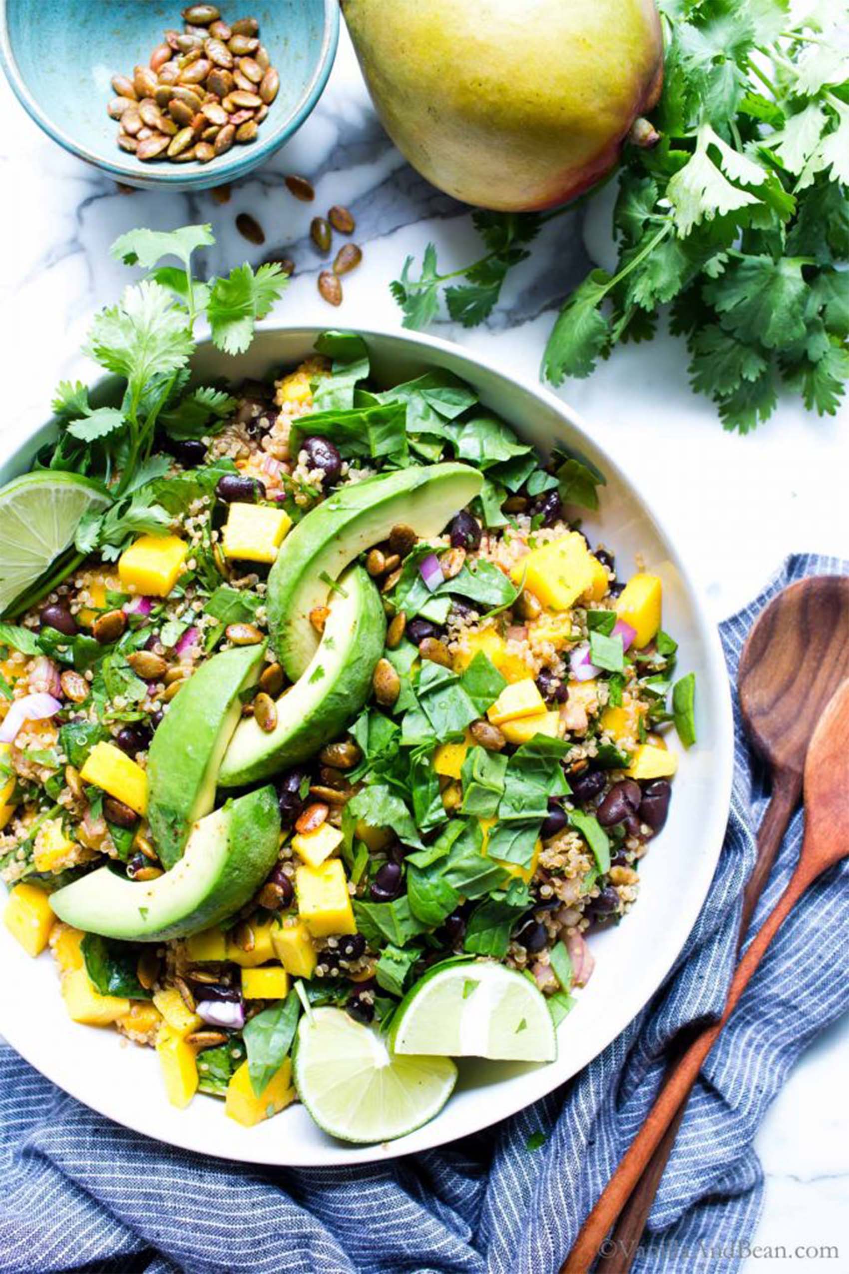 a bowl of black beans, rice, cubed mango and avocado