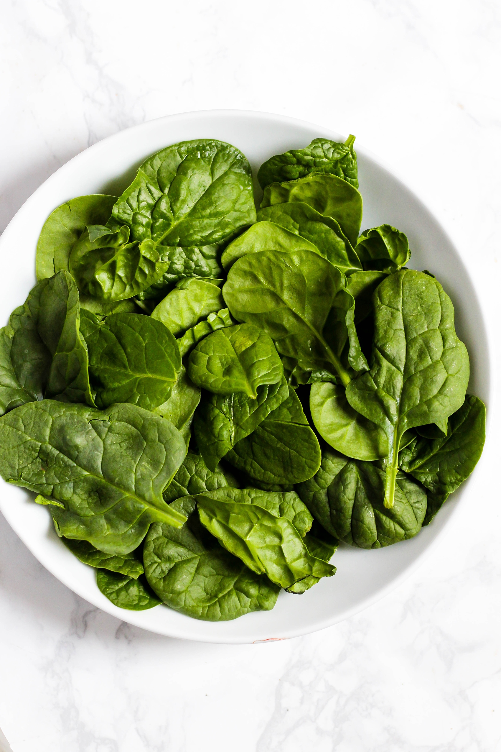 a plate of raw spinach