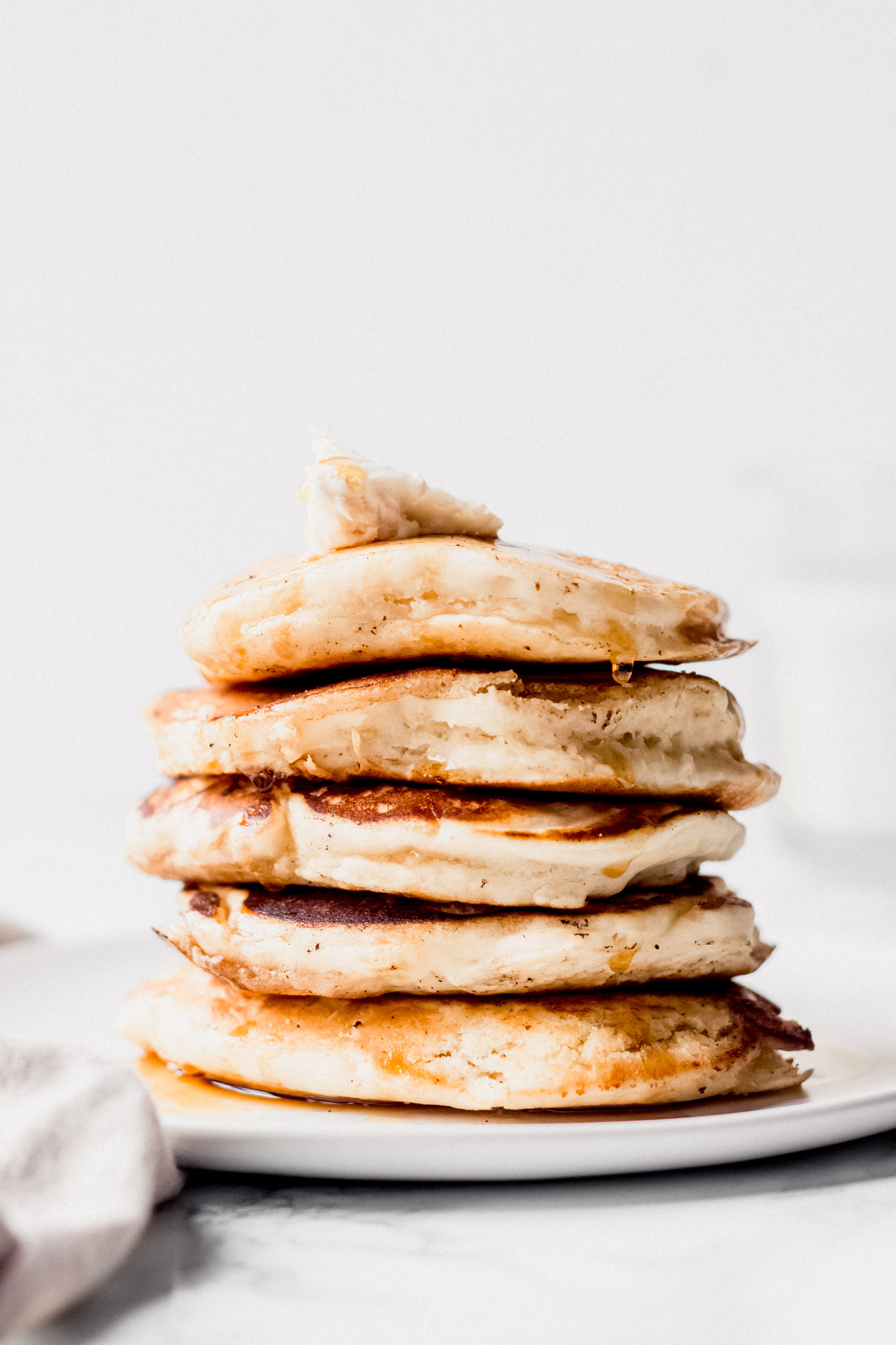 a stack of vegan pancakes topped with butter